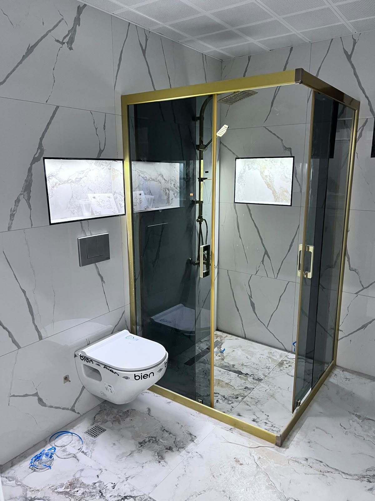 Gold profilli duşakabin ve mermer görünümlü banyo